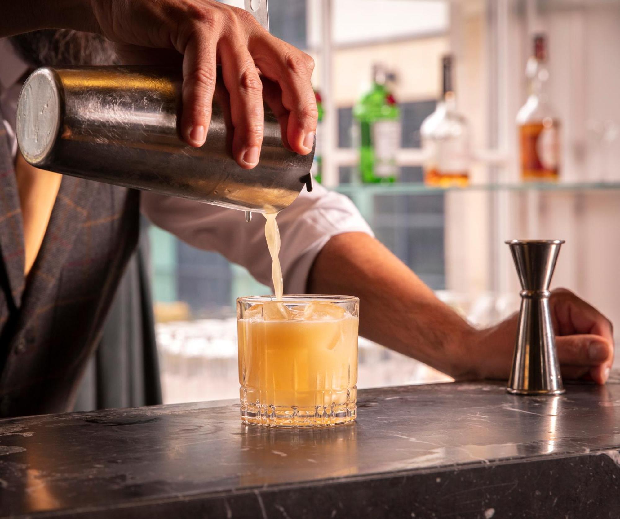 Schloss Roxburghe, Part Of Destination By Hyatt Bagian luar foto A bartender straining a cocktail